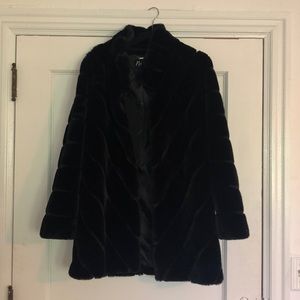 Fuzzy black winter coat, reaches upper thigh